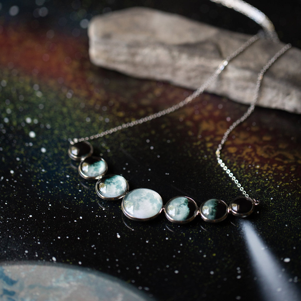 Varying Sized Curved Moon Phase Necklace in Silver